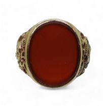 A 9ct gold carnelian signet ring, with flower embossed shoulders, Size W, weight 7.4gms Condition