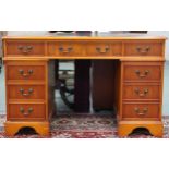 A 20th century pedestal desk with green leather skiver over central drawer flanked by four drawer