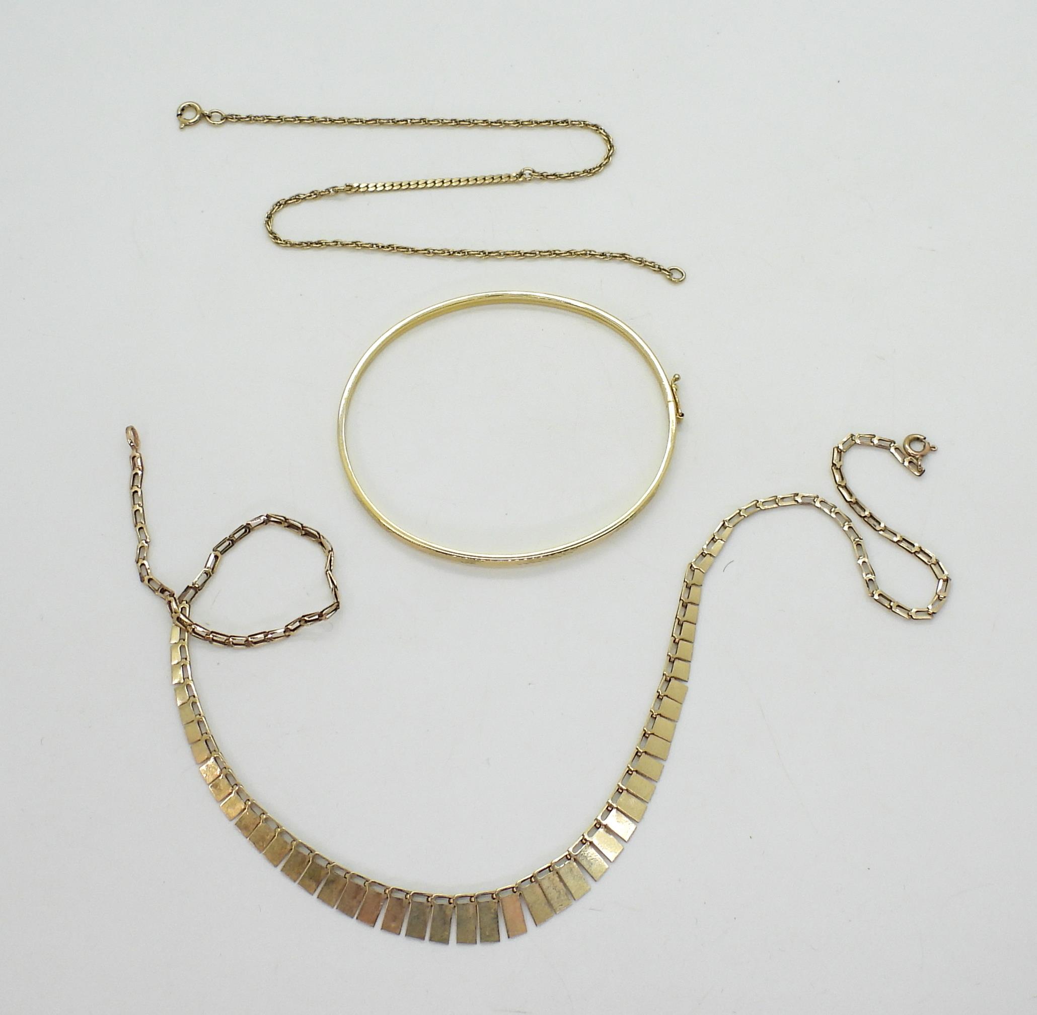 A 9ct gold bangle, 40cm fringe necklace, and a yellow metal chain bracelet, weight 9.8gms - Image 2 of 2
