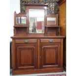 A late Victorian mahogany mirror back sideboard with carved surmount over bevelled mirror panes on