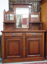 A late Victorian mahogany mirror back sideboard with carved surmount over bevelled mirror panes on