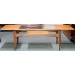 A mid 20th century G Plan teak coffee table with rectangular top with glass insert on shaped