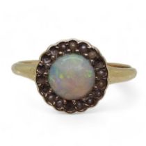 A bright yellow metal ring set with an opal and split pearls (some losses) size O1/2, weight 2.