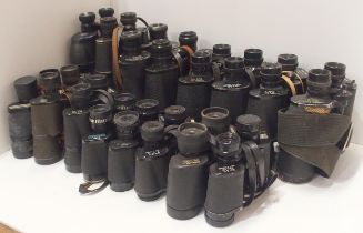 A large quantity of vintage binoculars, with manufacturers including Frank-Nipole, Regent,