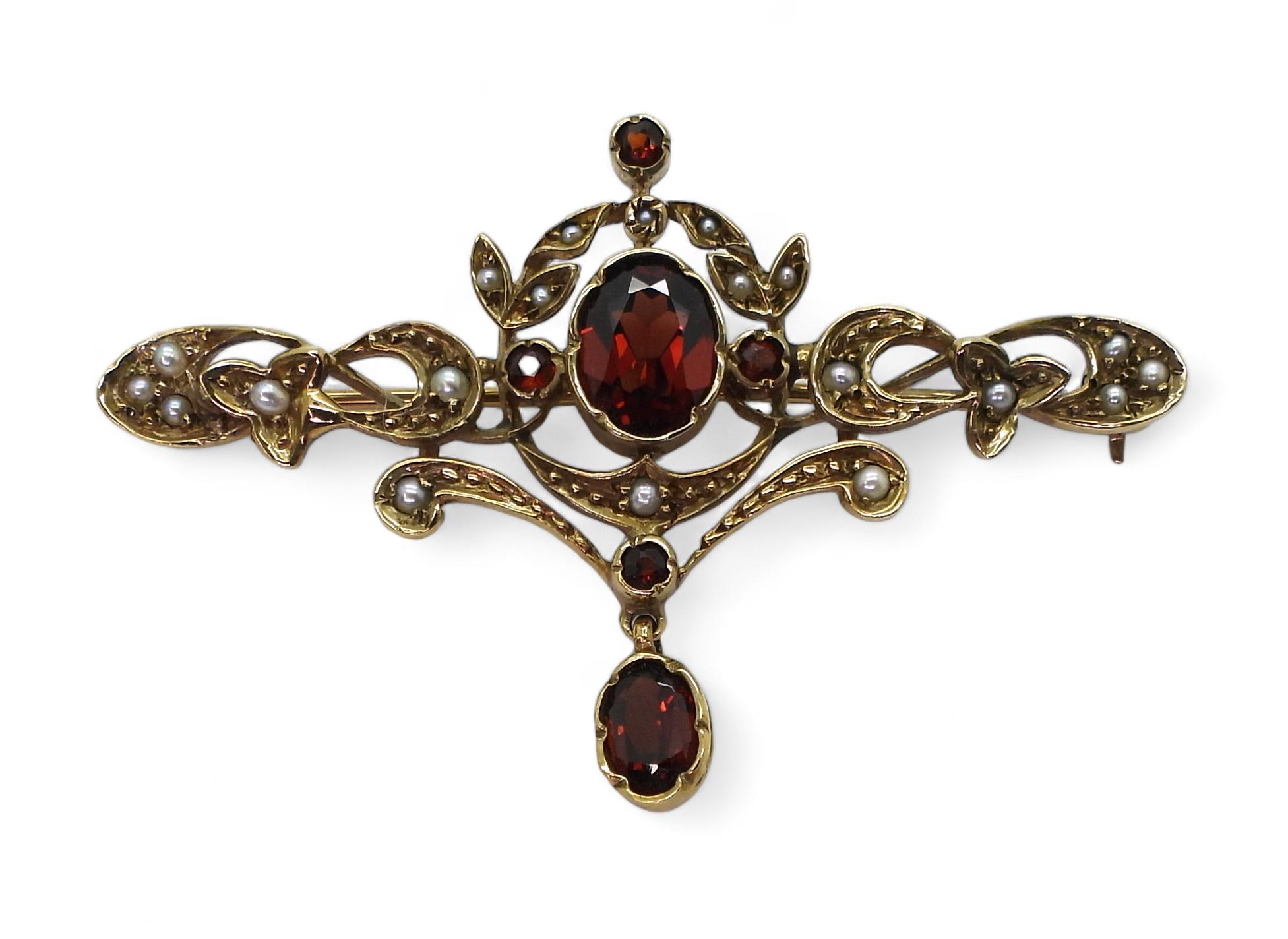 A 9ct gold garnet and pearl Art Nouveau style brooch, length 5cm, weight 5.5gms Condition Report: