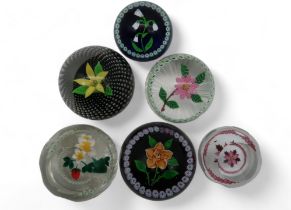 A collection of Caithness flower paperweights including Winter Flower, Rose, with 100 in number