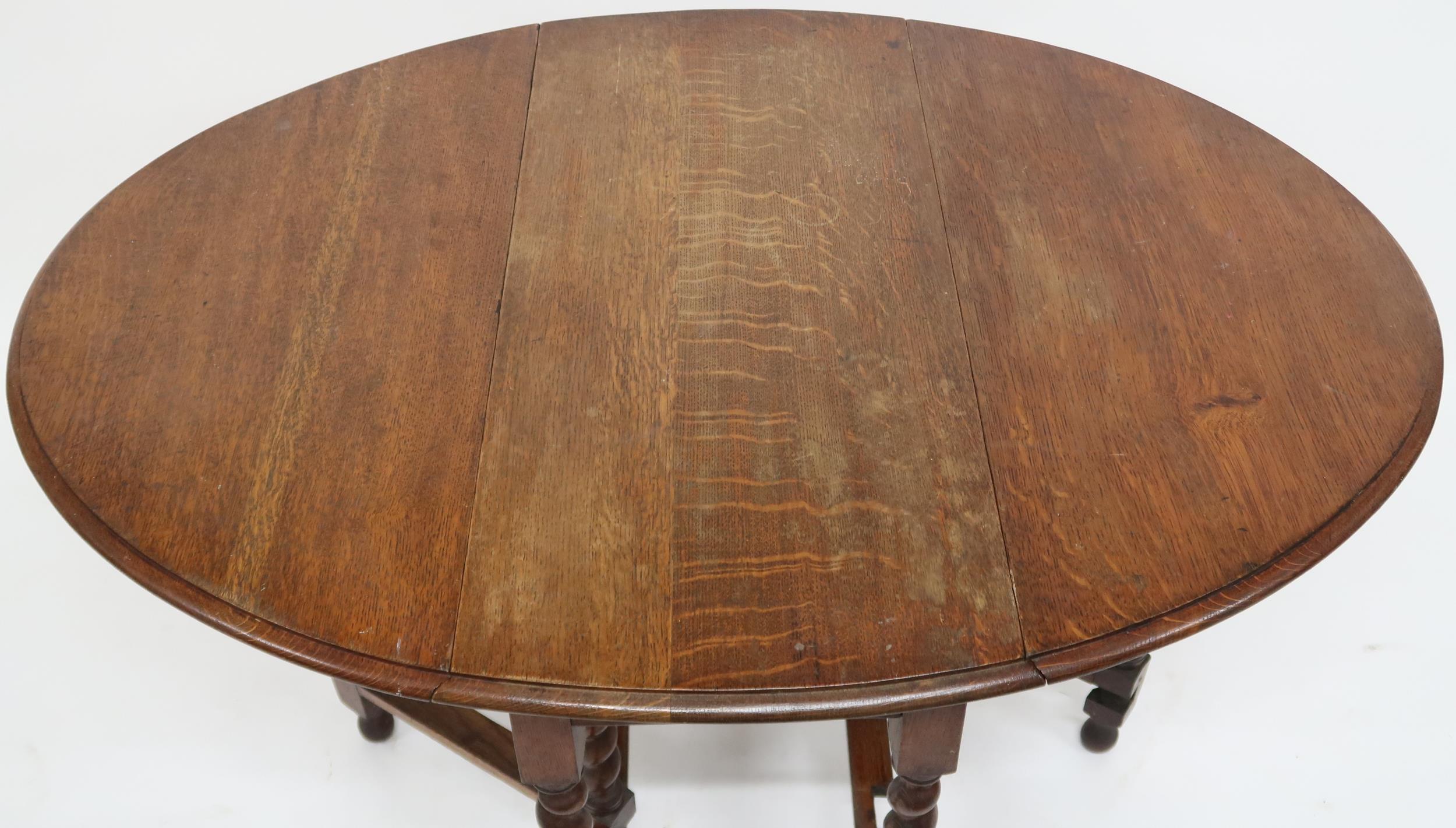A late Victorian oak drop leaf table on barley twist supports joined by stretchers, 73cm high x 91cm - Image 2 of 2