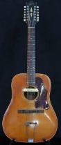 GIBSON A vintage 1960's Gibson B-45 12 string acoustic guitar with natural finish and  tortoise