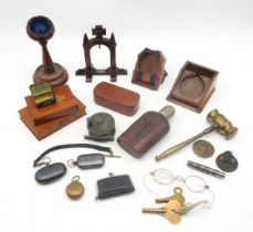 Four various treen pocket watch stands, a pair of yellow metal spectacles, the bridge stamped "1/