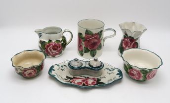 A collection of Wemyss ware all painted with cabbage roses including a tankard 14cm high, a wavy rim