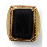A bright yellow metal ring, set with a black gem, stamped 90% with Chinese symbols, size R, weight