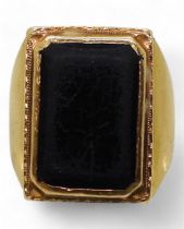 A bright yellow metal ring, set with a black gem, stamped 90% with Chinese symbols, size R, weight