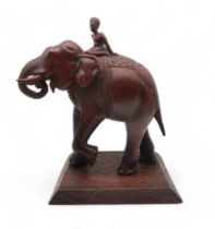 A carved wooden elephant and rider Condition Report:Available upon request