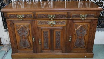 A Victorian oak sideboard with three drawers over further single drawer and three cabinet doors
