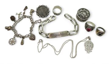 A continental silver pill box, silver identity bracelet, a Victorian 1887 coin in silver brooch