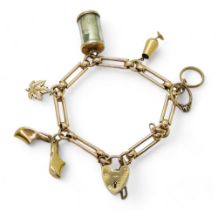 A 9ct gold decorative link charm bracelet with five attached charms, three in 9ct, one in 10k and