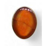A bright yellow metal signet ring set with a large carnelian intaglio carved with Brittania (