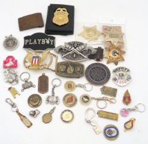 A collection of novelty American sheriff and police badges, Western-style belt buckles etc.,