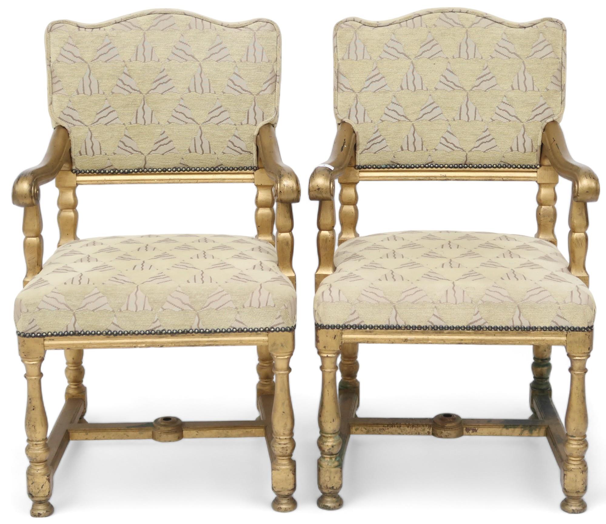A pair of early 20th century gilt framed theatre seats with beige geometric upholstery, scrolled