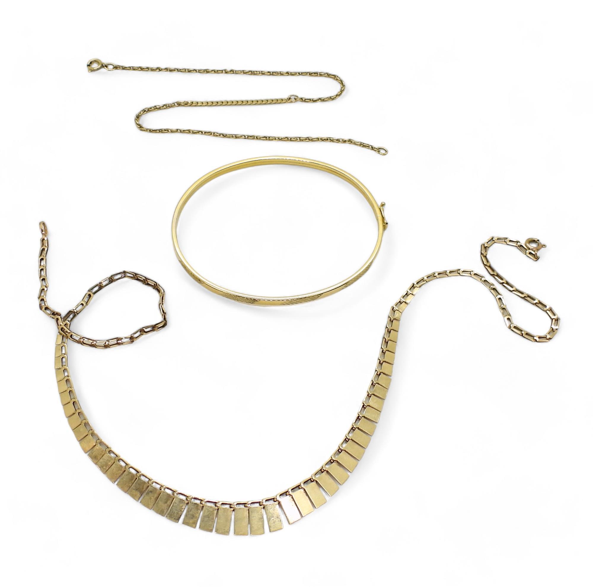 A 9ct gold bangle, 40cm fringe necklace, and a yellow metal chain bracelet, weight 9.8gms