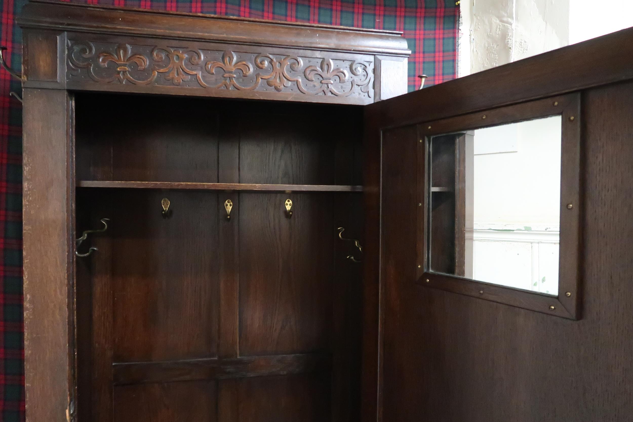 A 20th century oak single door hall robe with single panelled door flanked by sides mounted with - Image 2 of 2