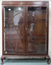 An early 20th century mahogany two door glazed display cabinet on cabriole supports, 124cm high x