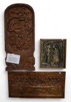 A Ugandan carved mahogany panel depicting village life, together with a gilded carved panel of
