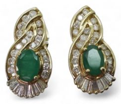 A pair of 14k gold emerald and diamond earrings set with estimated approx 0.50cts of brilliant and