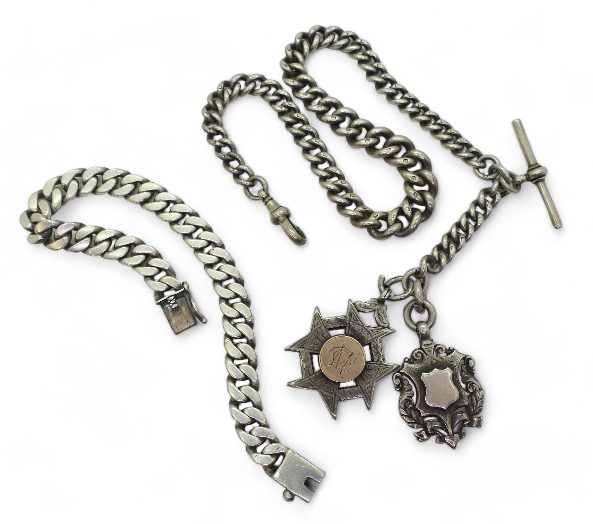 A heavy silver tapered fob chain with two silver medallions, hallmarked to every link, tapers from