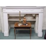 A 20th century white painted Rococo style fire surround, 118cm high x 163cm wide x 19cm deep, a