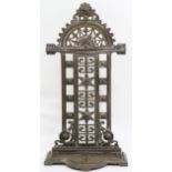 A 20th century cast iron "Falkirk" umbrella stand with pierced decorative back over removable drip