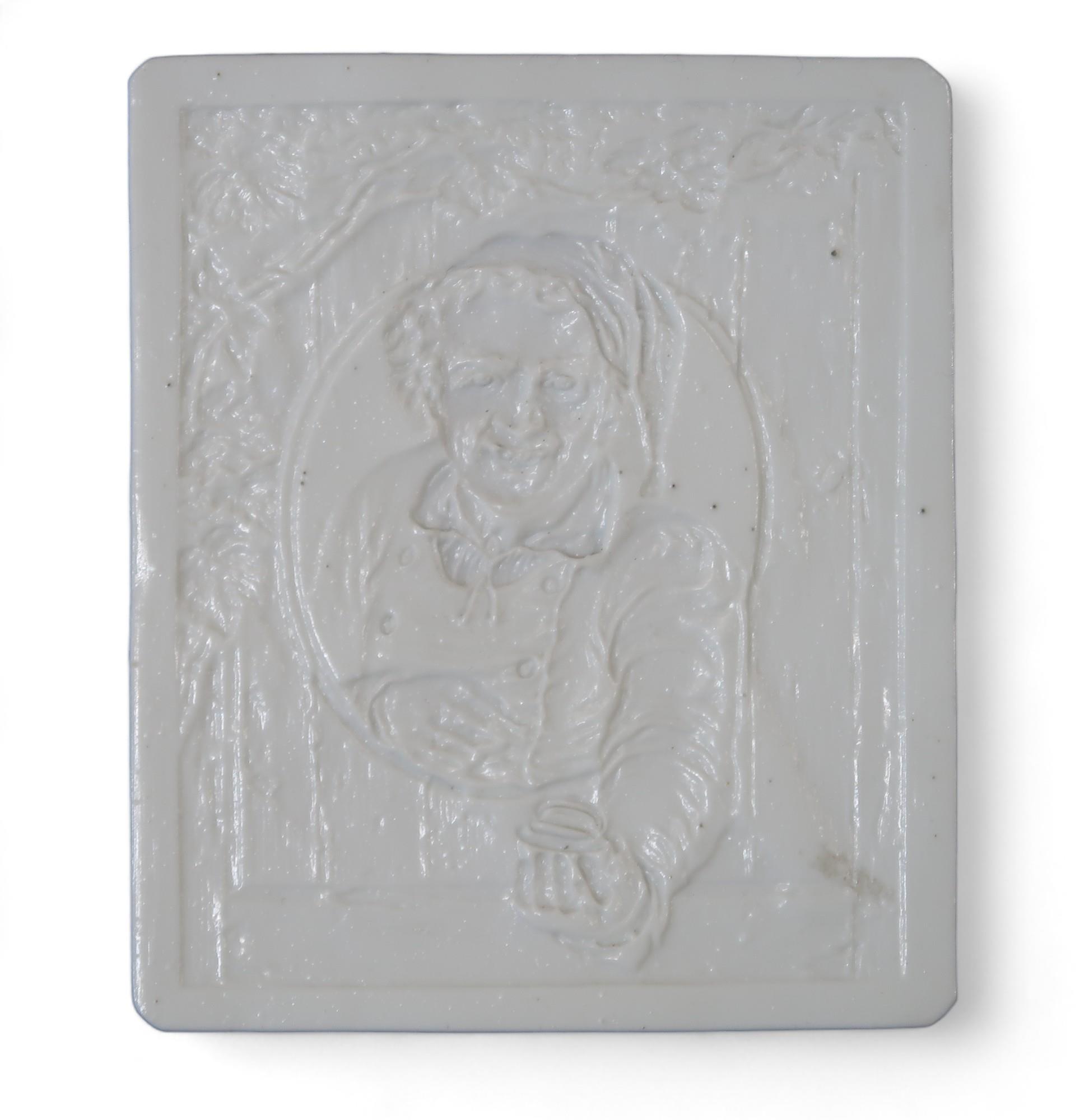 A lithophane panel depicting a smiling man in a hat Condition Report:Available upon request