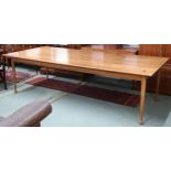 A large mid 20th century stained teak boardroom/library table on tapering supports terminating in