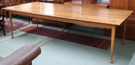 A large mid 20th century stained teak boardroom/library table on tapering supports terminating in