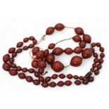 Two strings of cherry amber coloured beads, weight 158.1gms Condition Report:No condition report