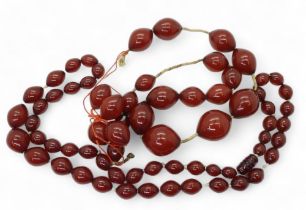 Two strings of cherry amber coloured beads, weight 158.1gms Condition Report:No condition report