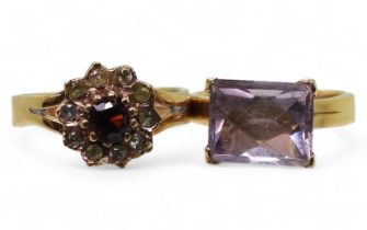 A yellow metal ring set with a fancy cut amethyst, size K, together with a garnet and clear gem