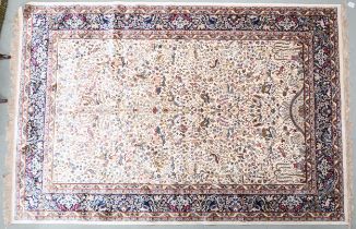 A cream ground full pile Kashmir rug with unique tree of life design with stylized animals within