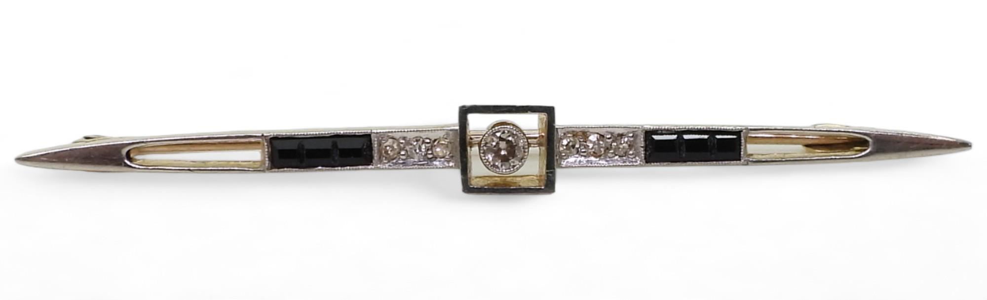 A 15ct gold diamond and black gem bar brooch, set with estimated approx 0.12cts of old cut diamonds,