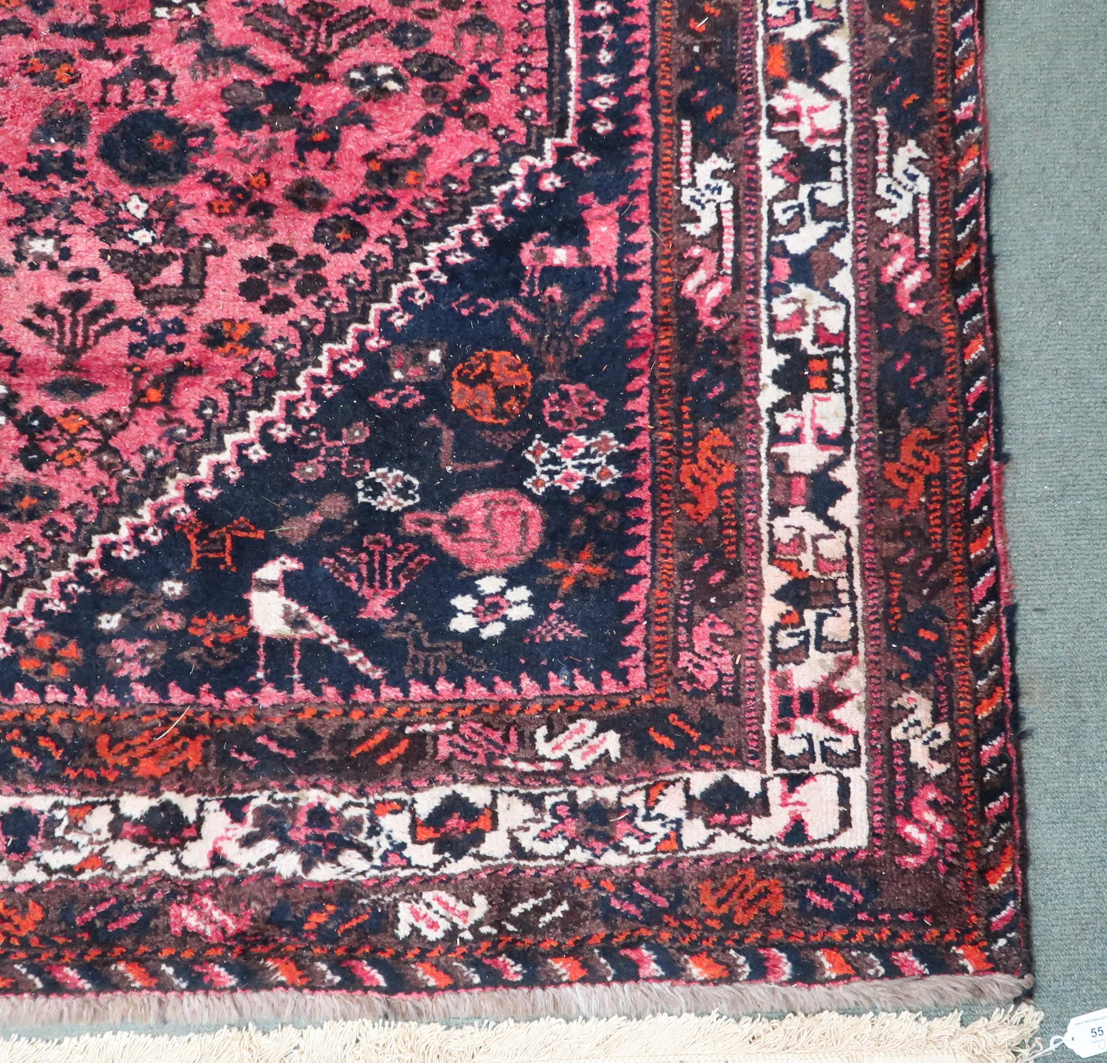 A red ground Hamadan rug with three diamond form medallions and dark blue spandrels within - Image 2 of 4