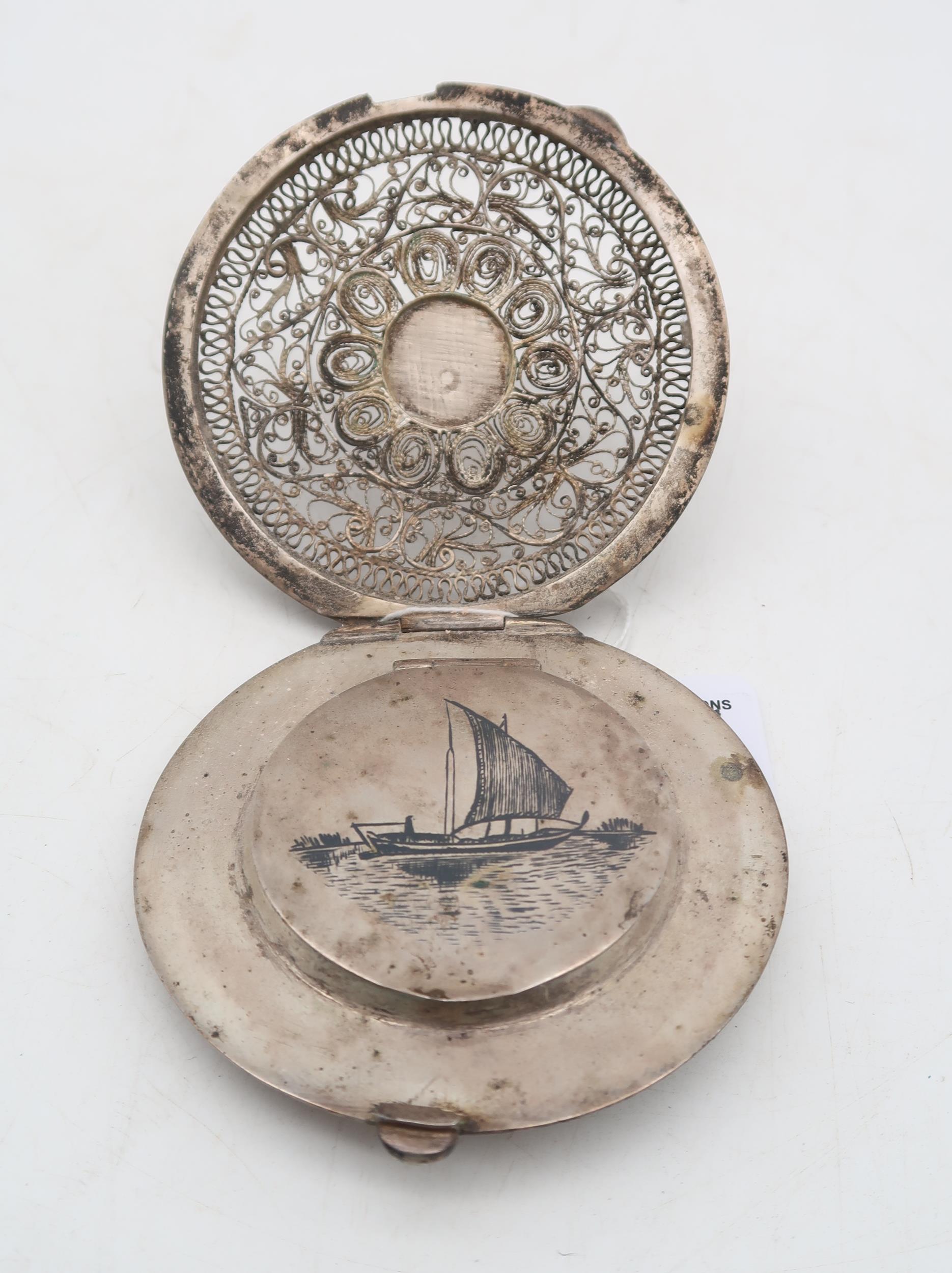An Egyptian white metal niello filigree powder compact, with decoration of boats to the lid and palm - Image 2 of 4