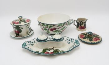 A collection of Wemyss ware cherry painted pottery including a two handled bowl, a chocolate cup and