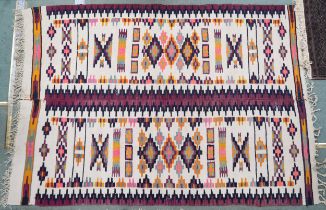 A cream ground Navajo style rug with all over geometric design, 209cm long x 151cm wide Condition