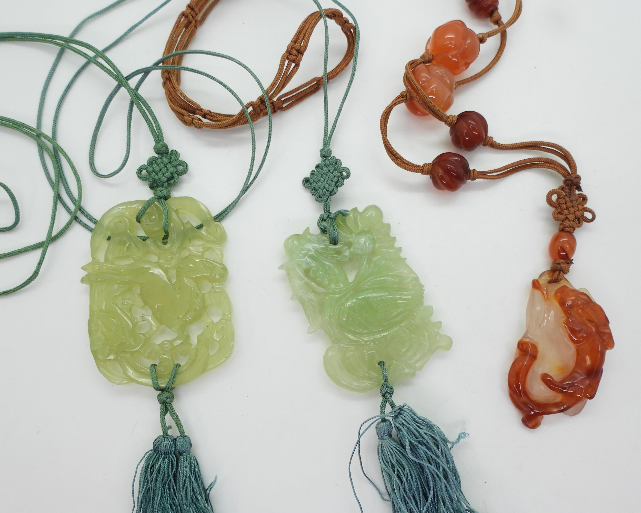 A Chinese carnelian necklace carved with a rabbit, together with two green hardstone examples carved - Image 2 of 6