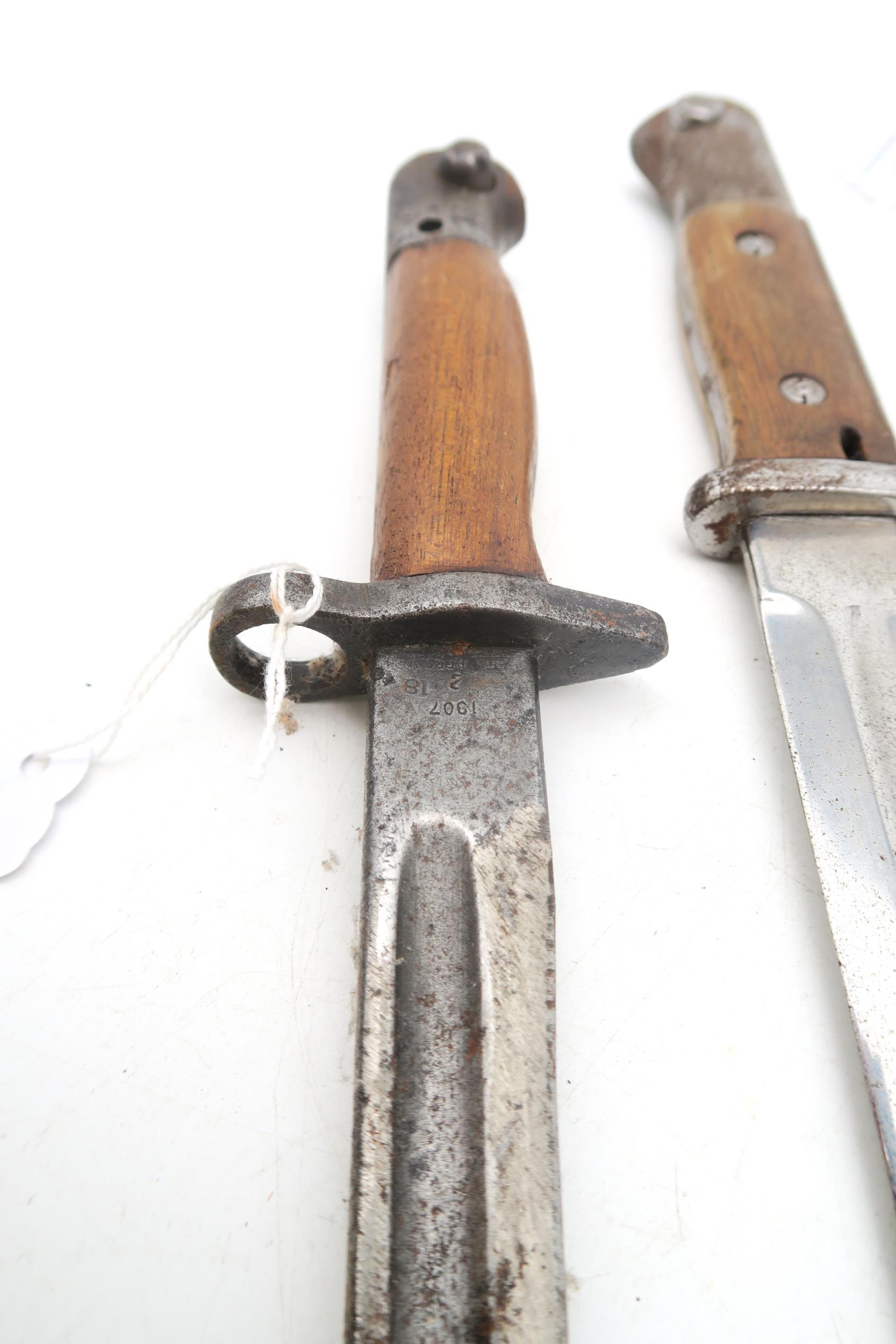 A WW1 British 1918-dated 1907 pattern bayonet by Sanderson, with scabbard; together with another, - Image 2 of 4
