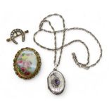 A yellow metal horseshoe brooch, weight 3.7gms, a silver amethyst set locket and chain, and a