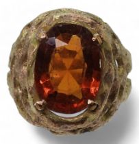 A yellow metal retro ring set with an orange gem stone, size J, weight 6.1gms  Condition Report: