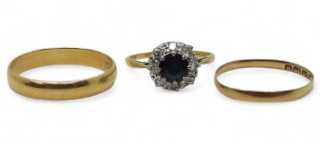 An 18ct and platinum, sapphire and diamond cluster ring, set with estimated approx 0.15cts of