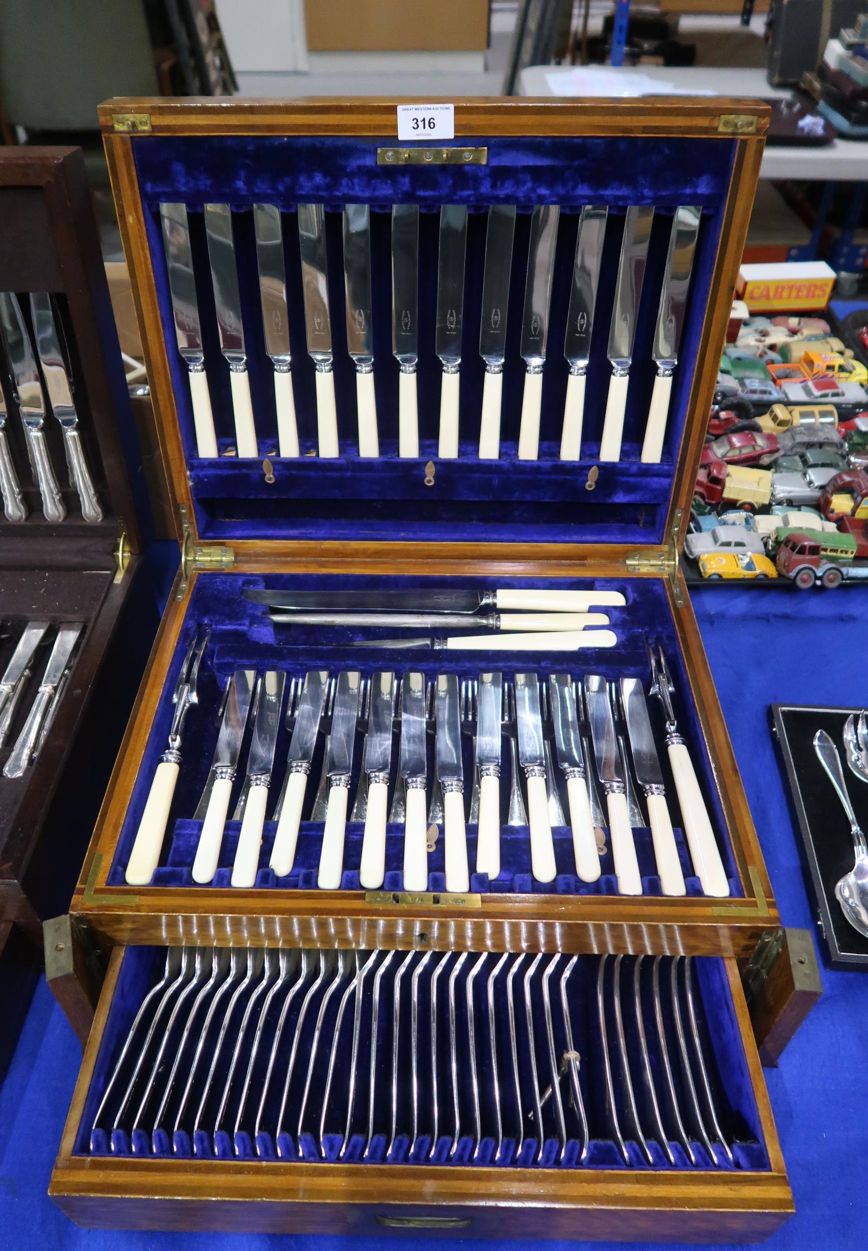 A two drawer canteen of stainless steel ivorine handled cutlery, by George Butler & Co & T T & Co,