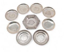 A collection of white metal coin dishes, inset with 1780 Thalers, a pair with engraved decoration to